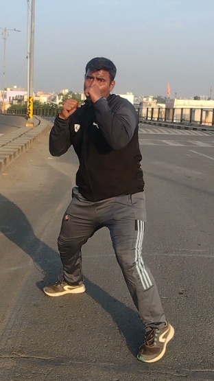 Coach Hardik Sharma in athletic martial arts stance
